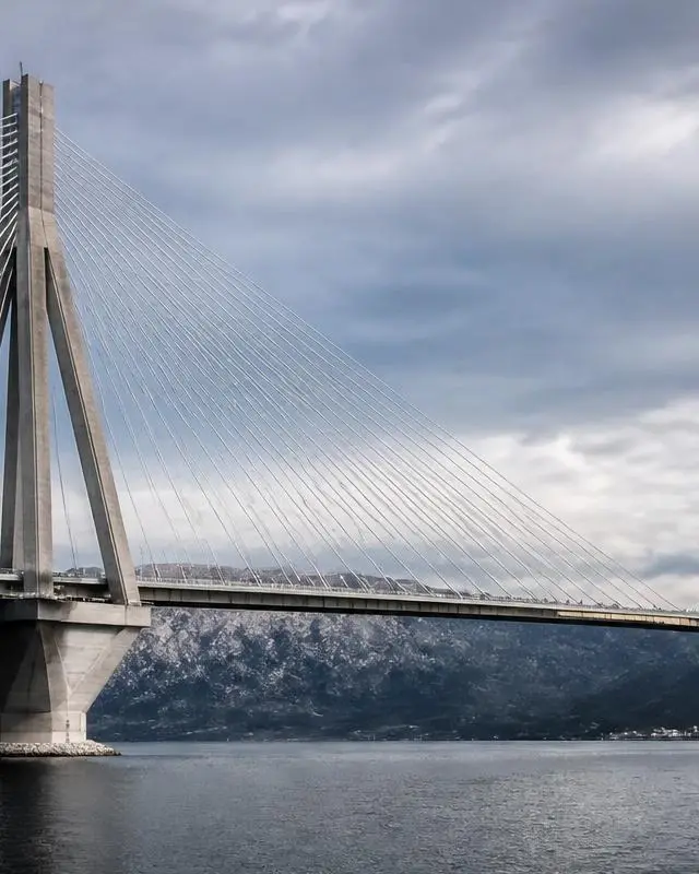Center panel of converging bridge cables and structural steel, symbolising values and integrity