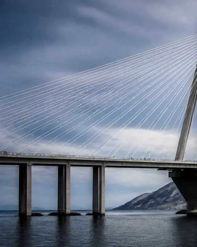Left panel of a cable stayed bridge under a cool neutral sky, symbolising vision
